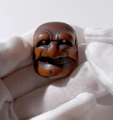 Lot 835 - TADATOSHI: A FINE NAGOYA SCHOOL WOOD MASK NETSUKE OF BUAKU