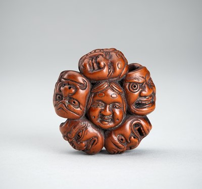 Lot 728 - A FINE BOXWOOD NETSUKE OF A GROUP OF MASKS, 19th CENTURY