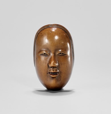 Lot 839 - A SIGNED BOXWOOD NOH MASK NETSUKE OF SHAKUMI, EDO PERIOD