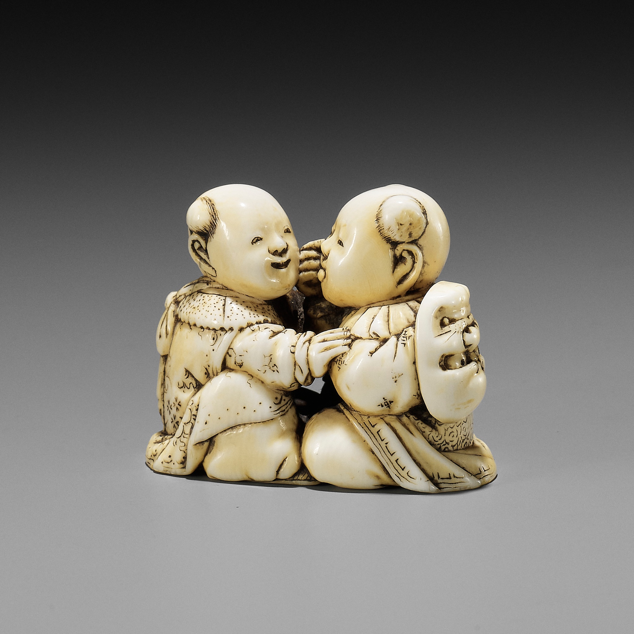 Lot 302 - TADACHIKA: AN IVORY NETSUKE OF TWO PLAYING