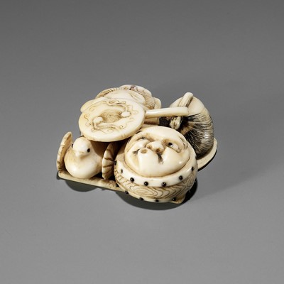 Lot 298 - A WALRUS TUSK NETSUKE OF A GROUP OF NOH THEATRE ACCOUTREMENTS