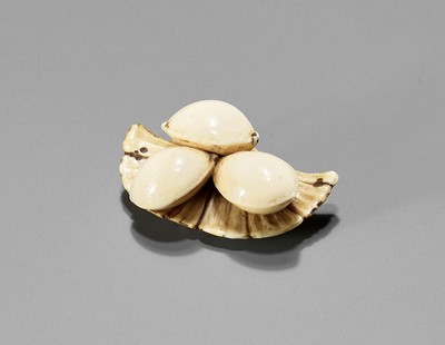 Lot 855 - NAOKAZU: AN IVORY NETSUKE DEPICTING GINKGO NUTS ON A LEAF