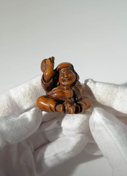 Lot 124 - MASANAO: A RARE WOOD NETSUKE OF DAIKOKU