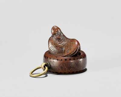 Lot 701 - A WOOD NETSUKE OF A COCKEREL ON A WAR DRUM