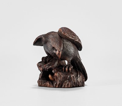 Lot 895 - MITSUNOBU: A WOOD NETSUKE OF AN EAGLE ON A ROCK, EDO PERIOD