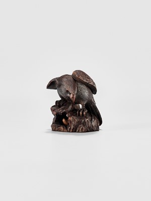 Lot 895 - MITSUNOBU: A WOOD NETSUKE OF AN EAGLE ON A ROCK, EDO PERIOD