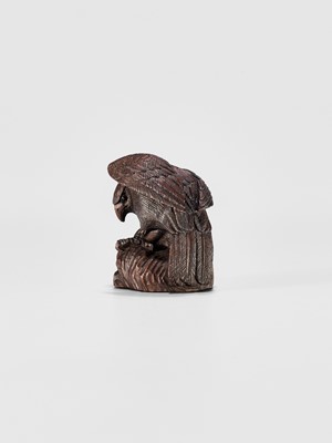 Lot 895 - MITSUNOBU: A WOOD NETSUKE OF AN EAGLE ON A ROCK, EDO PERIOD