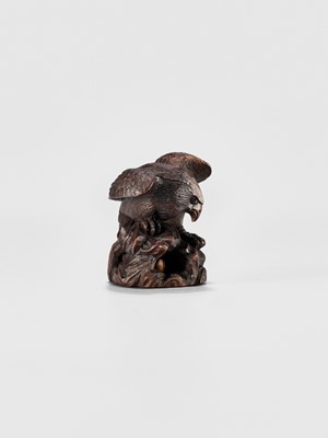 Lot 895 - MITSUNOBU: A WOOD NETSUKE OF AN EAGLE ON A ROCK, EDO PERIOD