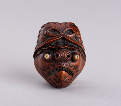 Lot 826 - MITSUAKI: A RARE WOOD NETSUKE OF A BAKEMONO MASK, MEIJI