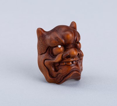 Lot 825 - RYUKEI: A WOOD MASK NETSUKE OF AN ONI, 19th CENTURY