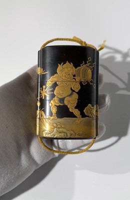A RARE AND EARLY BLACK AND GOLD LACQUER FOUR-CASE INRO DEPICTING RAIJIN AND FUJIN