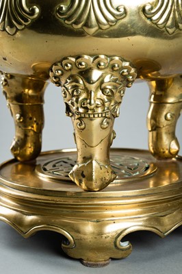 Lot 159 - A MASSIVE GILT BRONZE TRIPOD CENSER WITH STAND AND COVER, QING