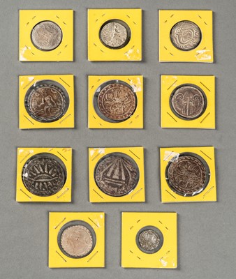 A GROUP OF ELEVEN SOUTHEAST ASIAN SILVER COINS