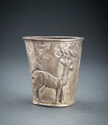 Lot 779 - A PERSIAN SILVER REPOUSSÉ ‘ANTELOPE’ BEAKER