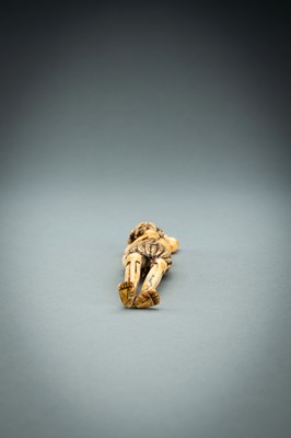 Lot 391 - A TALL IVORY NETSUKE OF ASHINAGA WITH A CANDLE