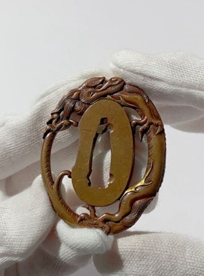 Lot 434 - A FINE AND SMALL KOFU SCHOOL TSUBA DEPICTING A DRAGON