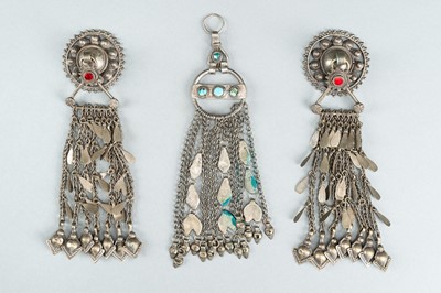 Lot 734 - THREE TRIBAL AFGHAN METAL ORNAMENTS WITH INSETS, c. 1950s