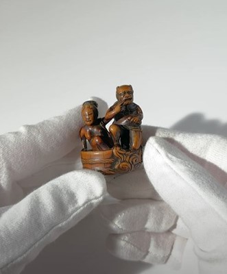 Lot 402 - HOMIN: A GOOD WOOD NETSUKE OF RAIJIN WITH BATHING WOMAN