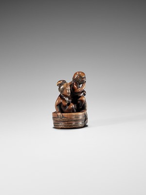 Lot 402 - HOMIN: A GOOD WOOD NETSUKE OF RAIJIN WITH BATHING WOMAN