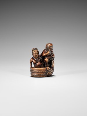 Lot 402 - HOMIN: A GOOD WOOD NETSUKE OF RAIJIN WITH BATHING WOMAN
