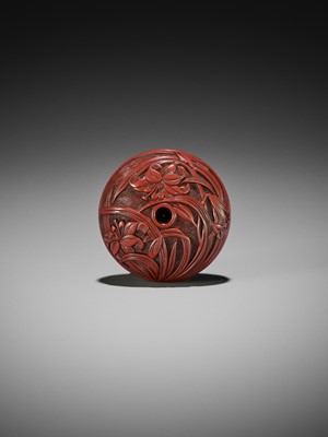 Lot 280 - A FINE TSUISHU (CARVED RED LACQUER) MANJU NETSUKE WITH LILIES