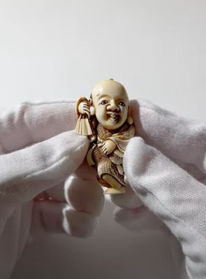Lot 361 - YOSHIMASA: AN IVORY NETSUKE OF FUKUSUKE
