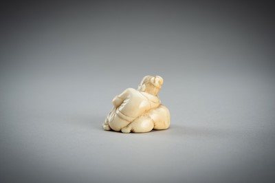 Lot 876 - AN IVORY NETSUKE OF A SAGE RECLINING ON A GOAT, EDO PERIOD