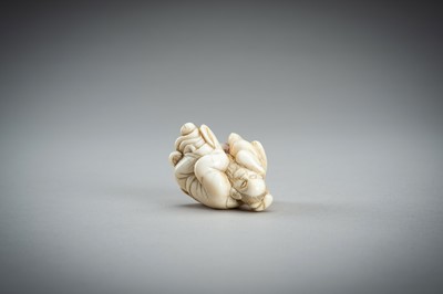 Lot 876 - AN IVORY NETSUKE OF A SAGE RECLINING ON A GOAT, EDO PERIOD