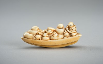 Lot 717 - AN IVORY NETSUKE OF THE LUCKY GODS ON A BOAT, EDO PERIOD