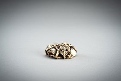Lot 736 - AN IVORY MANJU NETSUKE WITH FROG ON LOTUS AND PERSIMMONS, 19th CENTURY