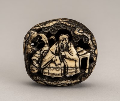 Lot 754 - JUKO TOSHIMITSU: A STAG ANTLER MANJU NETSUKE OF KAN´U, EDO PERIOD