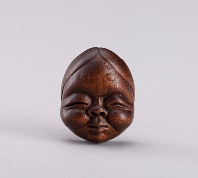 Lot 823 - MORITA: A WOOD SHUNGA MASK NETSUKE OF OKAME, MEIJI