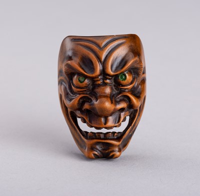 Lot 838 - A SANSHO STYLE WOOD MASK NETSUKE OF A DEMON, MEIJI