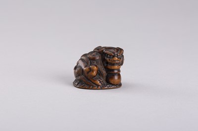 Lot 306 - A WOOD NETSUKE OF A SHISHI LION, EDO PERIOD