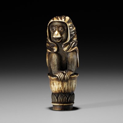 Lot 223 - KOKU: A STAG ANTLER KNIFE HANDLE IN THE FORM OF A MONKEY WITH A LOTUS CLOAK