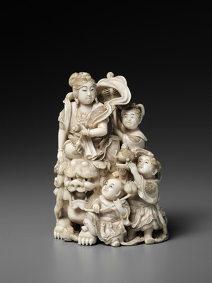 Lot 582 - KOMEI: AN IVORY OKIMONO OF MONJU BOSATSU WITH SHISHI AND CHILDREN