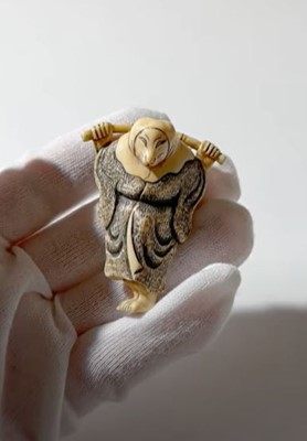 Lot 357 - AN IVORY NETSUKE OF A FOX PRIEST (HAKUZOSU) WITH BAMBOO CANE