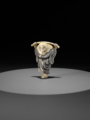 Lot 357 - AN IVORY NETSUKE OF A FOX PRIEST (HAKUZOSU) WITH BAMBOO CANE
