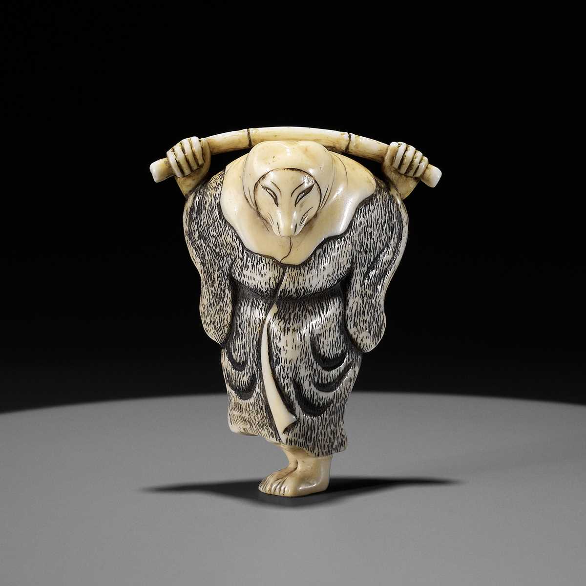 Lot 357 - AN IVORY NETSUKE OF A FOX PRIEST (HAKUZOSU) WITH BAMBOO CANE