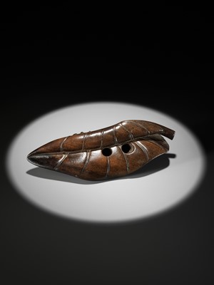 Lot 162 - KANMAN: AN EXCEPTIONAL AND LARGE KUROGAKI (BLACK PERSIMMON) WOOD NETSUKE OF A FROG ON A LOTUS LEAF