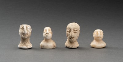 Lot 658 - A LOT WITH FOUR BACTRIAN WHITE MARBLE AND STONE IDOL HEADS