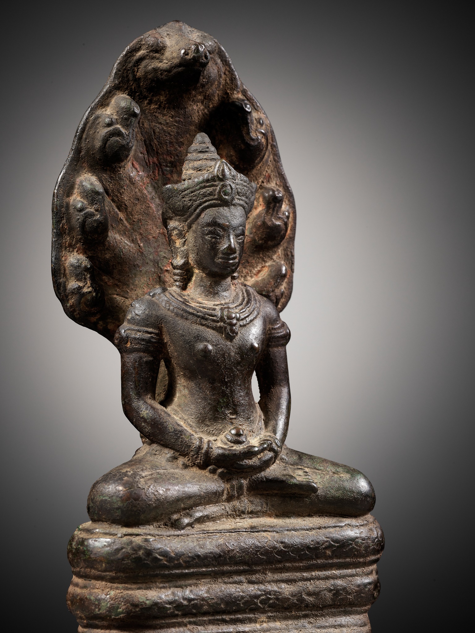 Lot 218 A BRONZE FIGURE OF BUDDHA MUCHALINDA KHMER Lot 218 A BRONZE FIGURE OF BUDDHA MUCHALINDA KHMER