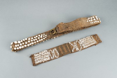 Lot 717 - LOT WITH TWO TRIBAL NAGALAND SHELL STUDDED BELTS AND AN APRON, c. 1900s