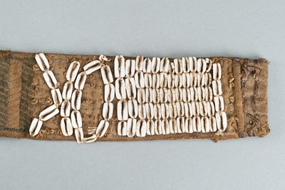 Lot 717 - LOT WITH TWO TRIBAL NAGALAND SHELL STUDDED BELTS AND AN APRON, c. 1900s