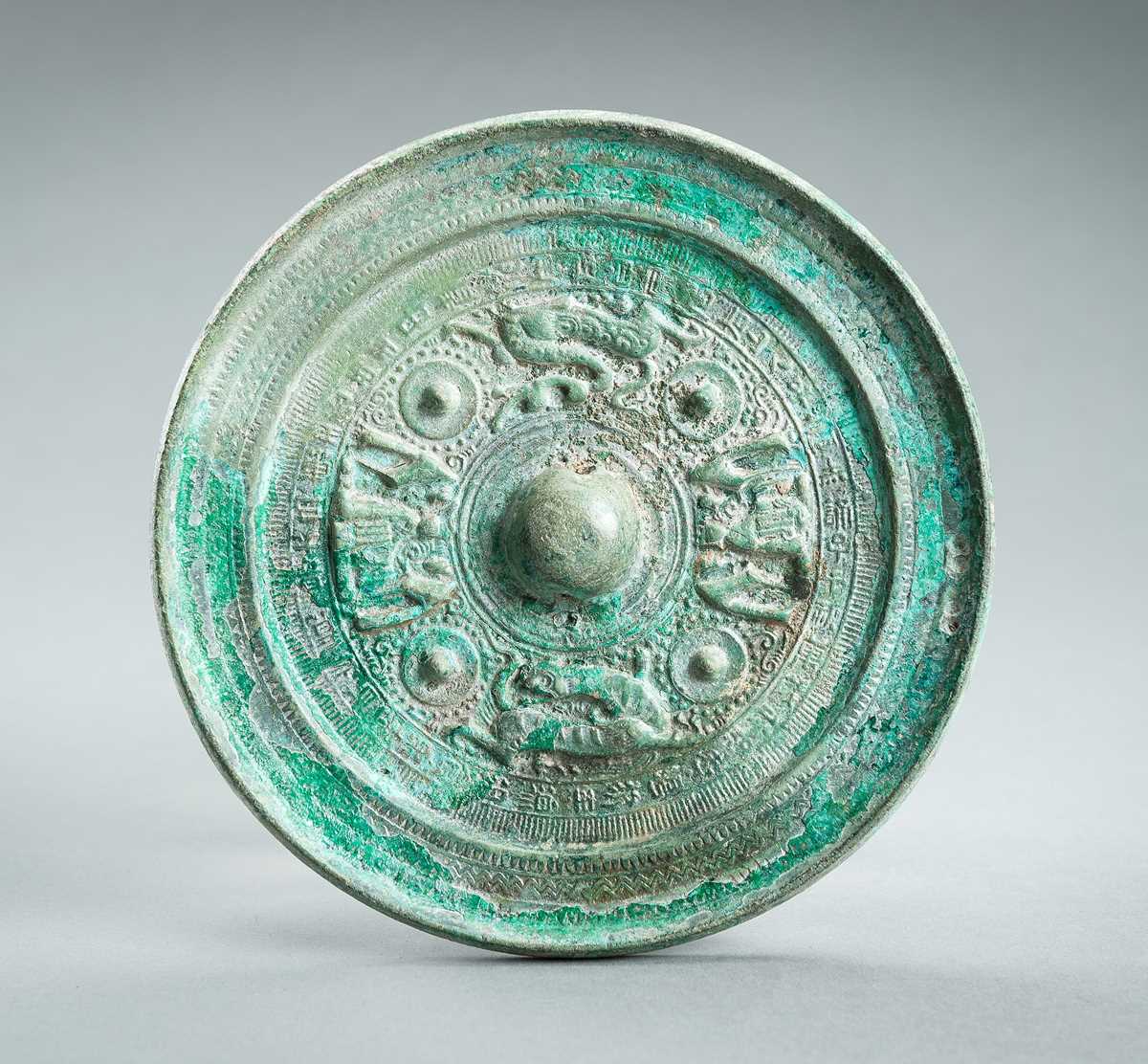 Lot 166 - AN ARCHAISTIC HAN STYLE ‘DEITIES AND BEASTS’ BRONZE MIRROR