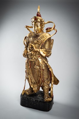 Lot 175 - A NEAR LIFE-SIZE GOLD LACQUERED WOOD FIGURE OF A GUARDIAN, QING