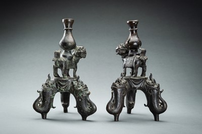 Lot 150 - A PAIR OF FIGURAL CHINESE BRONZE LAMP STANDS, MING DYNASTY