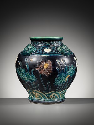 Lot 84 - AN EARLY FAHUA-GLAZED ‘LOTUS’ JAR, GUAN, WITH FOUR LION-MASK HANDLES, MING DYNASTY