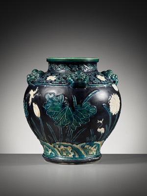 Lot 84 - AN EARLY FAHUA-GLAZED ‘LOTUS’ JAR, GUAN, WITH FOUR LION-MASK HANDLES, MING DYNASTY