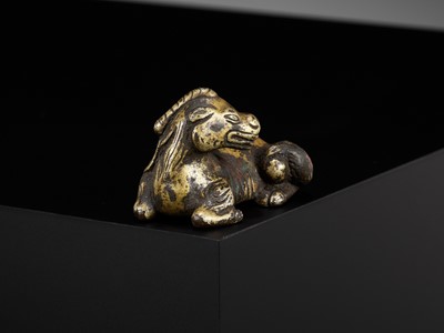 Lot 621 - A GILT-BRONZE ‘XINIU’ WEIGHT, MING DYNASTY